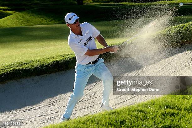 John Senden of Australia hits out of a bunker on the 9th hole in the second round of the Northern Trust Open at the Riviera Country Club on February...