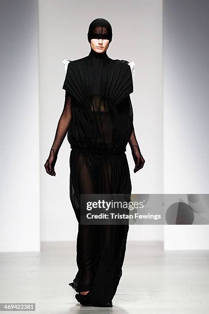 Model walks the runway wearing Teruhiro Hasegawa outfits at the Central Saint Martins show at London Fashion Week AW14 at Somerset House on February...