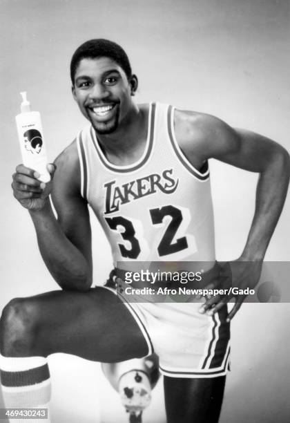 Half length portrait of basketball player Magic Johnson, wearing his Los Angeles Lakers no 32 shirt, advertising a hair product, 1980.
