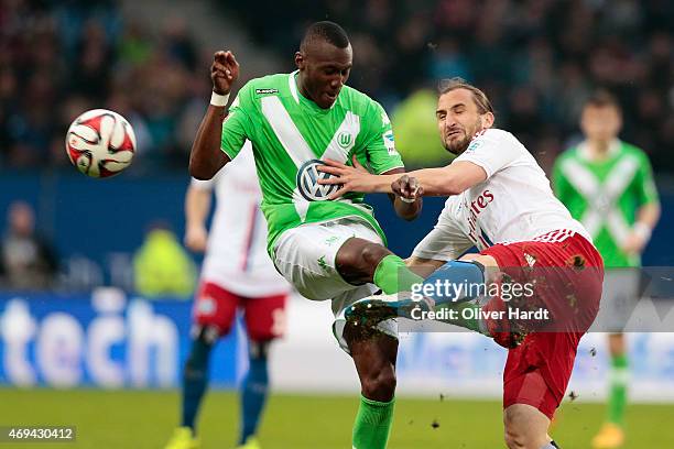 Petr Jiracek of Hamburg and Josuha Guilavogui of Wolfsburg compete for the ball during the First Bundesliga match between Hamburger SV and VfL...