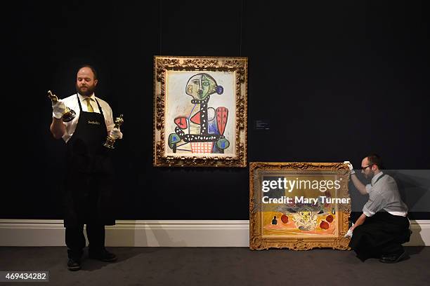 Two gallery technicians pose with Picasso's 'Femme au chignon dans un fauteuill', , 1948 and Henri Matisse's 'Anemones et gremones' and two Academy...