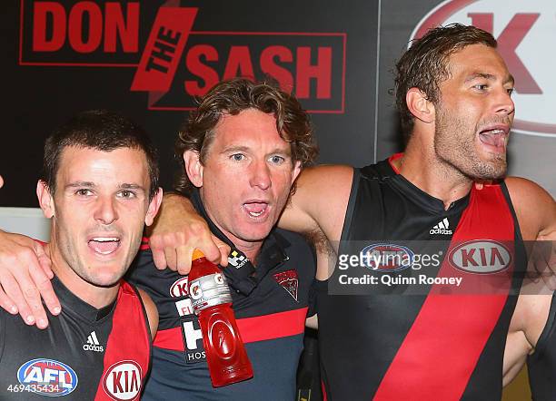 James Hird the coach of the bombers sings the song with Brent Stanton and Tom Bellchambers of the Bombers after winning the round two AFL match...