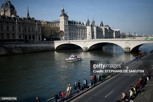 Competitors in the 39th Paris Marathon run past the Conciergerie in Paris on April 12, 2015. AFP PHOTO / STEPHANE DE SAKUTIN