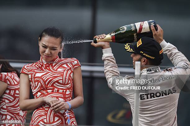 Mercedes AMG Petronas F1 Team's British driver Lewis Hamilton celebrates after winning the Formula One Chinese Grand Prix in Shanghai on April 12,...