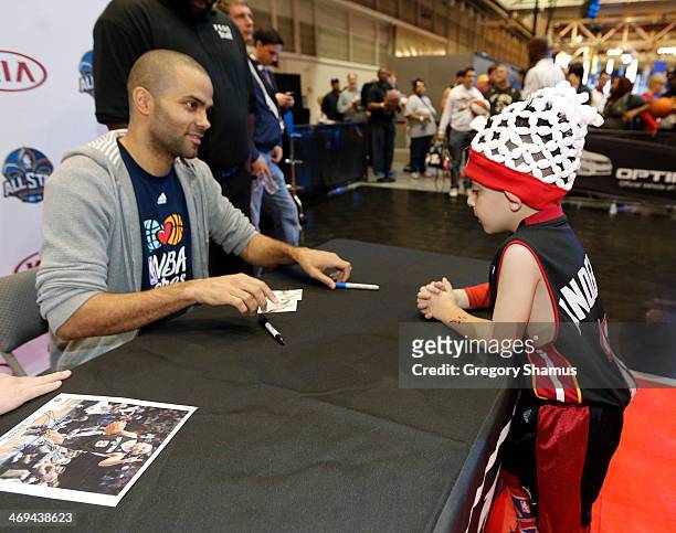 Tony Parker of the San Antonio Spurs does a autograph session at the KIA MVP court during the 2014 NBA All-Star Jam Session at the Ernest N. Morial...