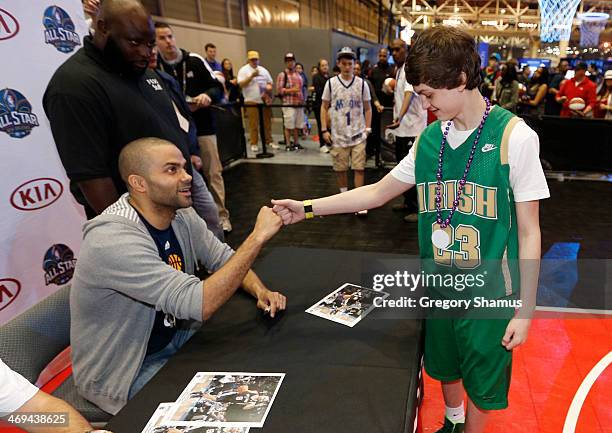 Tony Parker of the San Antonio Spurs does a autograph session at the KIA MVP court during the 2014 NBA All-Star Jam Session at the Ernest N. Morial...