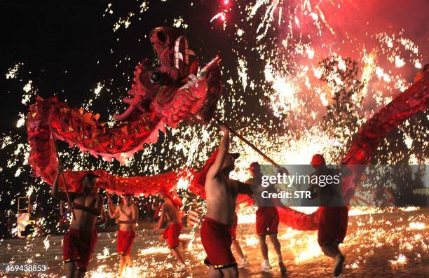 This picture taken on February 14, 2014 shows Chinese villagers perform a dragon dance to celebrate the lantern festival in Yongchuan, Chongqing...