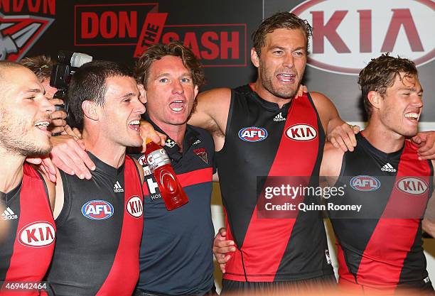 James Hird the coach of the bombers sings the song with David Zaharakis, Brent Stanton, Tom Bellchambers and Jake Melksham of the Bombers after...