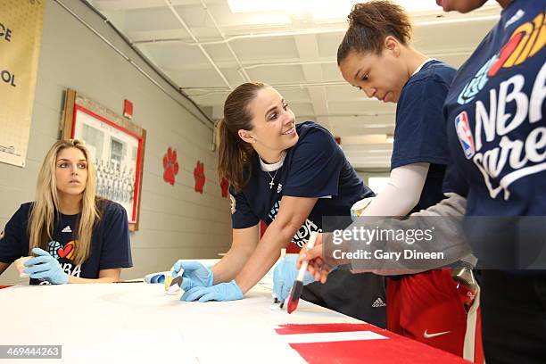 Elena Delle Donne of the Chicago Sky and Becky Hammon of the San Antonio Silver Stars paint during the NBA Cares All-Star Day of Service "LEARN" with...