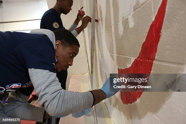 DeMar DeRozan of the Toronto Raptors paints during the NBA Cares All-Star Day of Service "LEARN" with City Year as part of the 2014 NBA All-Star...