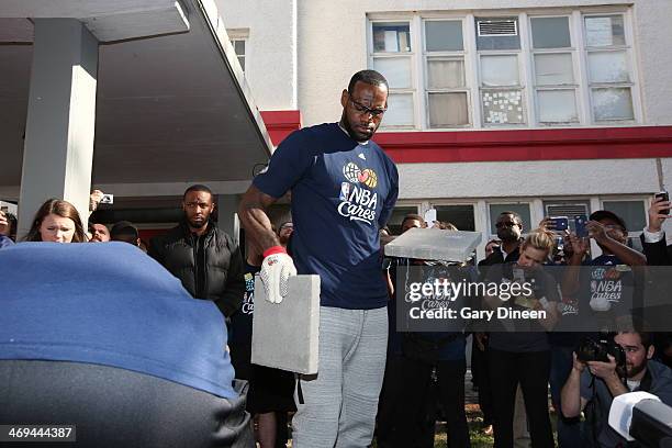 LeBron James of the Miami Heat helps carry bricks during the NBA Cares All-Star Day of Service "LEARN" with City Year as part of the 2014 NBA...