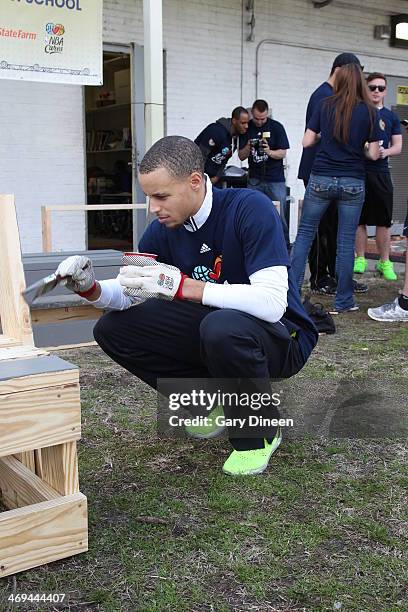 Stephen Curry of the Golden State Warriors helps paint during the NBA Cares All-Star Day of Service "LEARN" with City Year as part of the 2014 NBA...