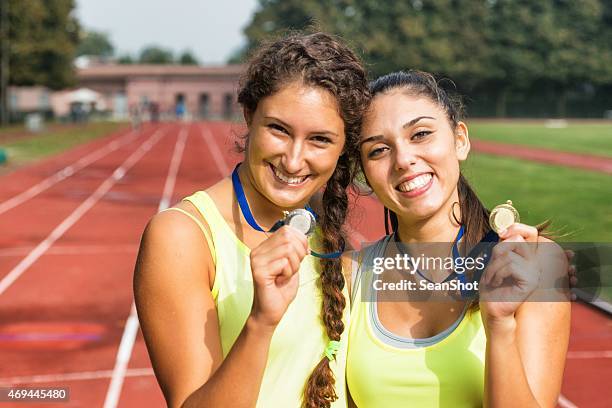 athletes showing medals - marathon medal stock pictures, royalty-free photos & images