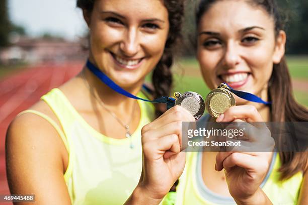 athletes showing medals - medalist stock pictures, royalty-free photos & images