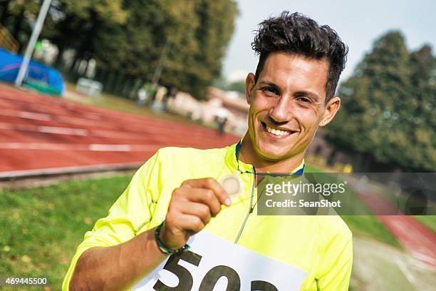 athlete showing medals - sportsperson medal stock pictures, royalty-free photos & images
