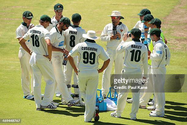 The Tigers huddle at drinks break during day four of the Sheffield Shield match between the Western Australia Warriors and the Tasmania Tigers at the...