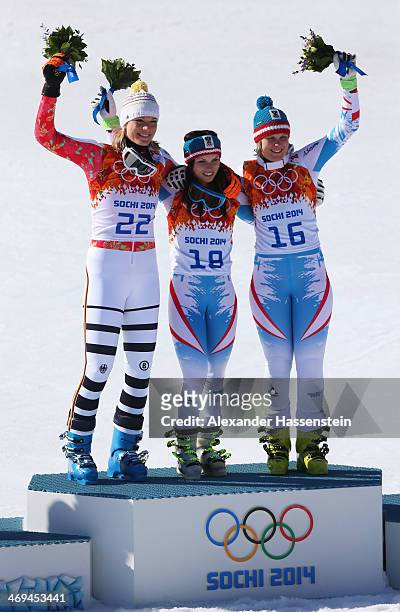 Silver medalist Maria Hoefl-Riesch of Germany, gold medalist Anna Fenninger of Austria and bronze medalist Nicole Hosp of Austria celebrate on the...
