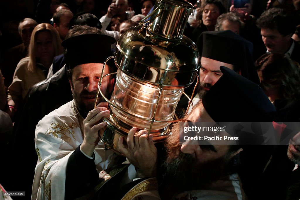 Priest hold the at the Holy Light at the church of the Holy...