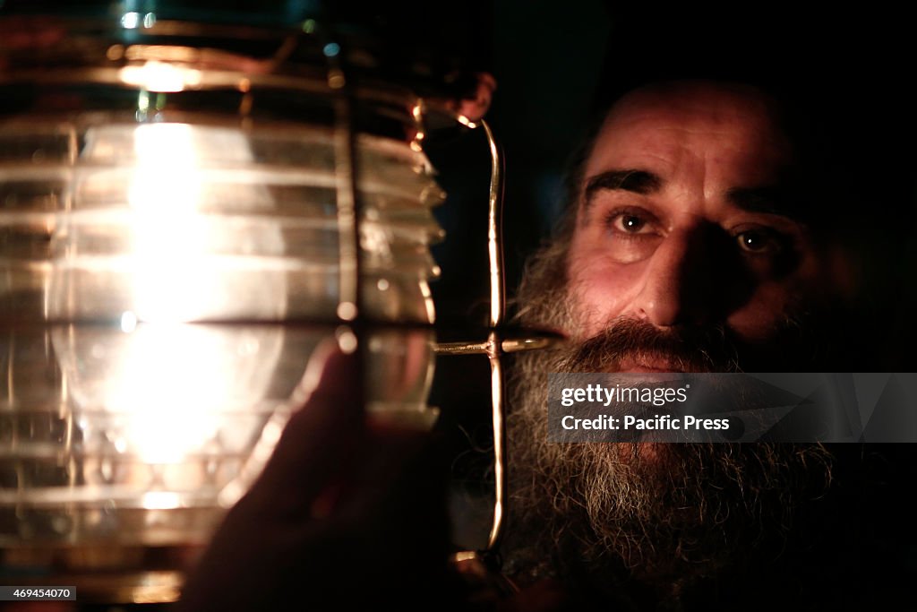 A priest holds the Holy light at the church of the Holy...