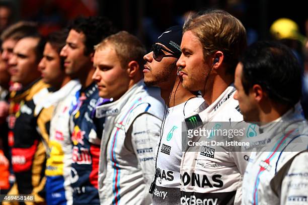 Lewis Hamilton of Great Britain and Mercedes GP stands next to his fellow drivers as the national anthem is played before the Formula One Grand Prix...