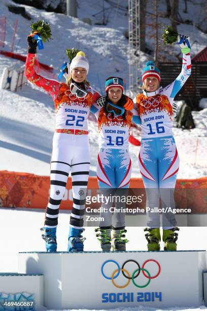Silver medalist Maria Hoefl-Riesch of Germany, gold medalist Anna Fenninger of Austria and bronze medalist Nicole Hosp of Austria celebrate on the...