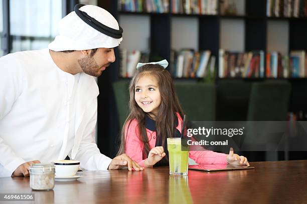 arabian father caring his daughter - dubai cares stock pictures, royalty-free photos & images