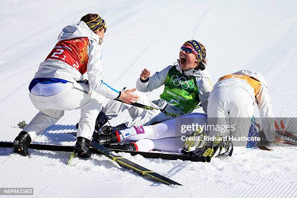 Ida Ingemarsdotter, Emma Wiken, Anna Haag and Charlotte Kalla of Sweden celebrate winning the gold medal in the Women's 4 x 5 km Relay during day...