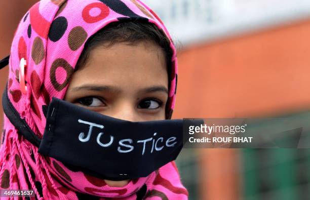 Young daughter of a member of the Association of Parents of Disappeared Persons wears a black band across her face during a protest against the...