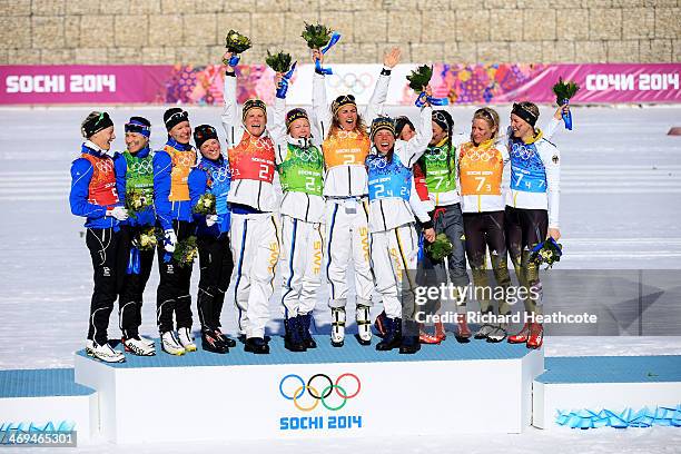 Silver medalists Anne Kylloenen, Aino-Kaisa Saarinen, Kerttu Niskanen and Krista Lahteenmaki of Finland, gold medalists Ida Ingemarsdotter, Emma...