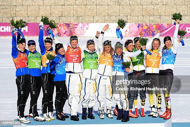 Silver medalists Anne Kylloenen, Aino-Kaisa Saarinen, Kerttu Niskanen and Krista Lahteenmaki of Finland, gold medalists Ida Ingemarsdotter, Emma...