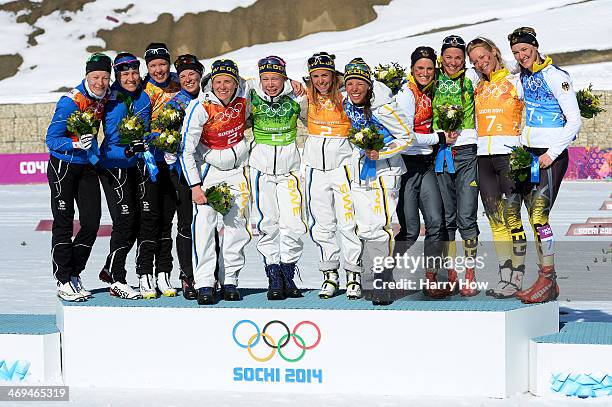 Silver medalists Anne Kylloenen, Aino-Kaisa Saarinen, Kerttu Niskanen and Krista Lahteenmaki of Finland, gold medalists Ida Ingemarsdotter, Emma...