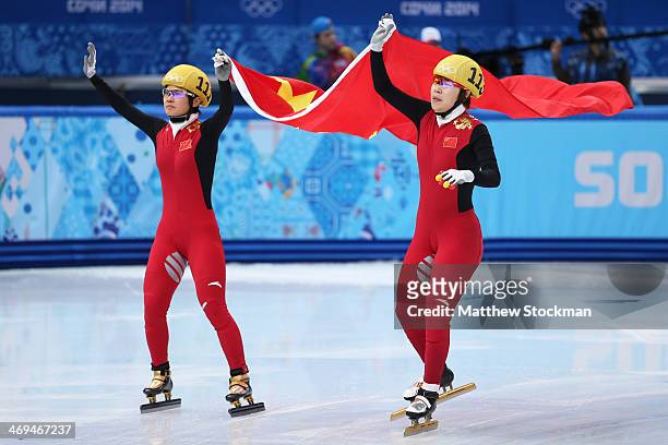 Yang Zhou of China celebrates winning the gold medal with Jianrou Li of China during the Ladies' 1500 m Final Short Track Speed Skating on day 8 of...