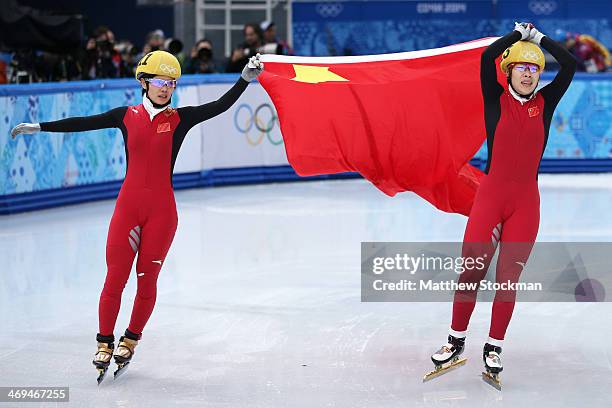 Yang Zhou of China celebrates winning the gold medal with Jianrou Li of China during the Ladies' 1500 m Final Short Track Speed Skating on day 8 of...