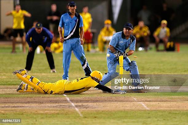 Bevan Bennell of Western Australia slides to score the winning runs during the Imparja Cup Final between Western Australia and New South Wales at...