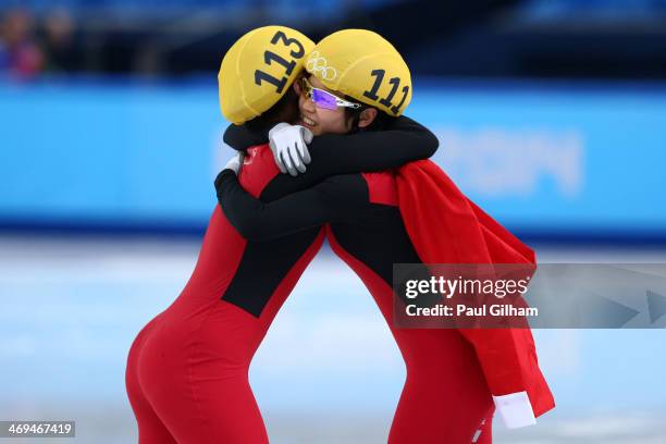 Yang Zhou of China is congratulated by Jianrou Li of China after winning the gold medal during the Ladies' 1500 m Final Short Track Speed Skating on...