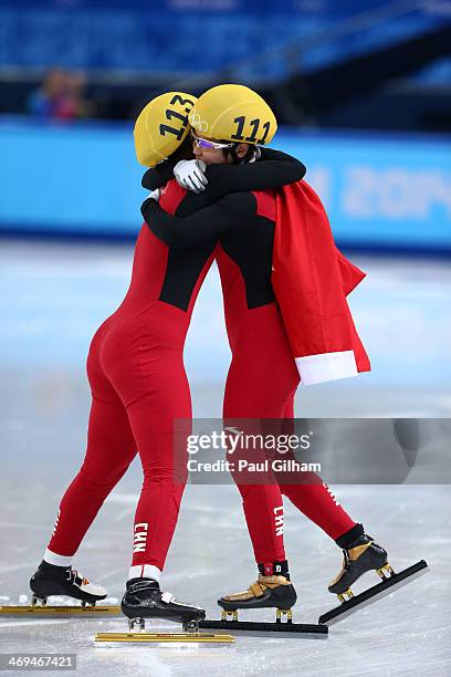 Yang Zhou of China is congratulated by Jianrou Li of China after winning the gold medal during the Ladies' 1500 m Final Short Track Speed Skating on...