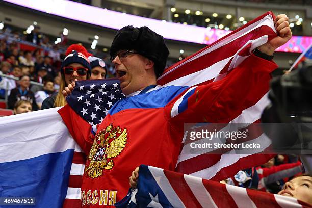 Fan wears a Russian jersey and holds an American flag before the game between Russia and the United States during the Men's Ice Hockey Preliminary...