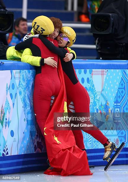 Yang Zhou of China is congratulated by Jianrou Li of China after winning the gold medal during the Ladies' 1500 m Final Short Track Speed Skating on...