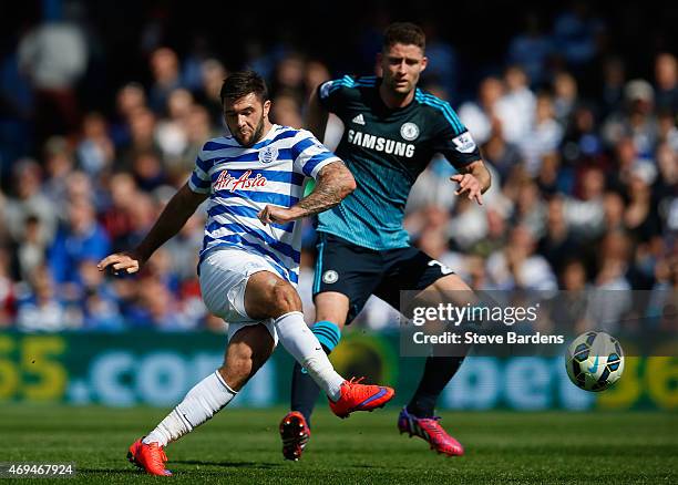 Charlie Austin of QPR shoots under pressure from Gary Cahill of Chelsea during the Barclays Premier League match between Queens Park Rangers and...