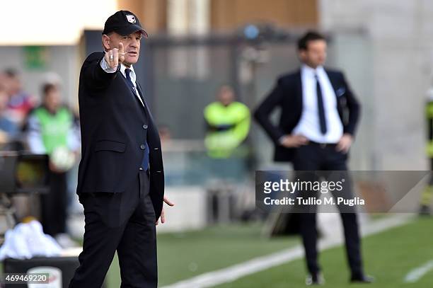 Head coach Giuseppe Iachini of Palermo issues instructions as head coach Andrea Stramaccioni of Udinese looks on during the Serie A match between...