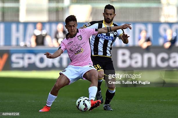 Paulo Dybala of Palermo and Giampiero Pinzi of Udinese compete for the ball during the Serie A match between Udinese Calcio and US Citta di Palermo...