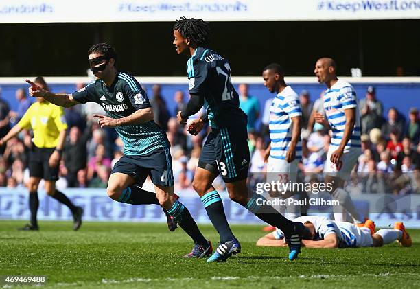 Cesc Fabregas of Chelsea celebrates scoring the opening goal with Juan Cuadrado of Chelsea during the Barclays Premier League match between Queens...