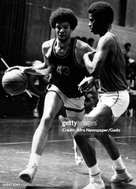 All Metropolitan basketball player Lionel Harris plays against Aaron Coniston in an Urban Coalition Basketball League game, Washington, DC, 1970.