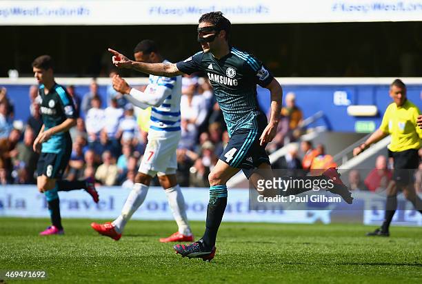 Cesc Fabregas of Chelsea celebrates scoring the opening goal during the Barclays Premier League match between Queens Park Rangers and Chelsea at...