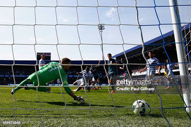 Cesc Fabregas of Chelsea scores the first goal past Robert Green of QPR during the Barclays Premier League match between Queens Park Rangers and...