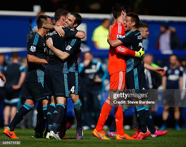 Cesc Fabregas of Chelsea hugs Branislav Ivanovic of Chelsea as they celebrate victory in the Barclays Premier League match between Queens Park...