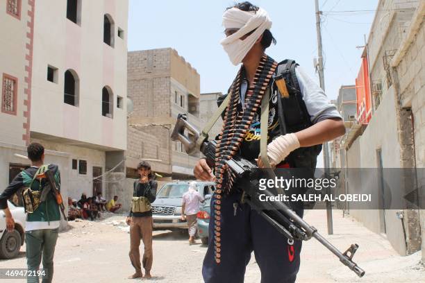 Yemeni fighters, opposing the Huthi rebels and supporting the government forces loyal to President Hadi, stand on a street in Aden's northern...