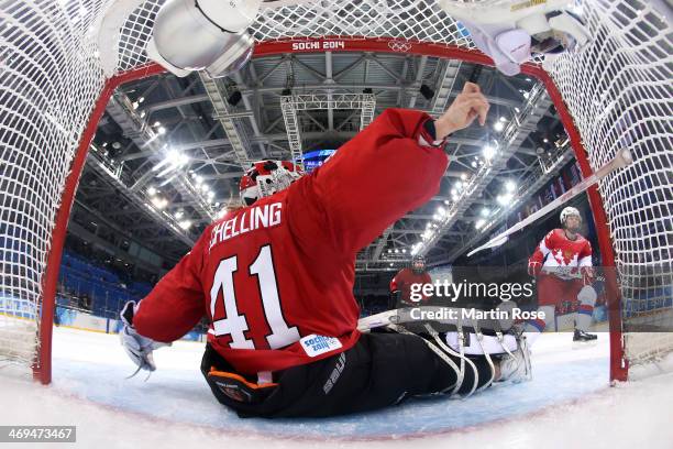 Yekaterina Lebedeva of Russia takes a shot at goal against Florence Schelling of Switzerland during the Women's Ice Hockey Playoffs Quarterfinal game...