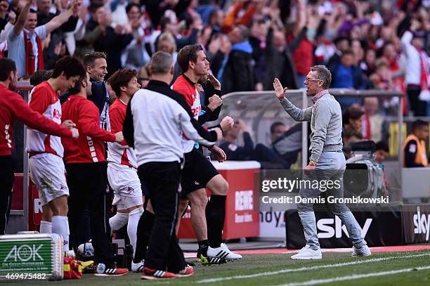Head coach Peter Stoeger of 1. FC Koeln celebrates after the final whistle during the Bundesliga match between 1. FC Koeln and 1899 Hoffenheim at...