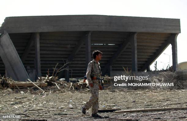 An armed Shiite Huthi rebel stands on April 12, 2015 at the compound of Sanaa's al-Yarmuk football club which was hit by a reported air strike by the...